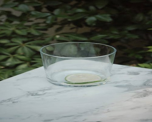 Segelas air putih segar dengan irisan lemon di meja kerja yang rapi